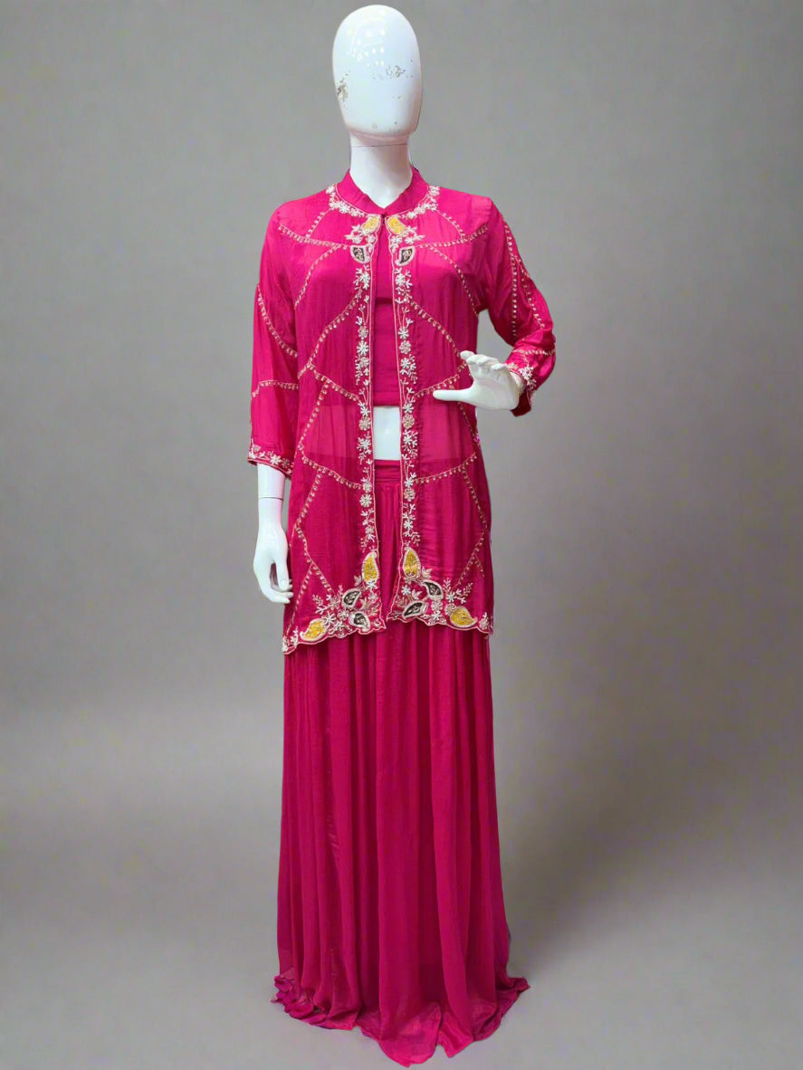 Mannequin wearing a pink embroidered outfit in a store setting